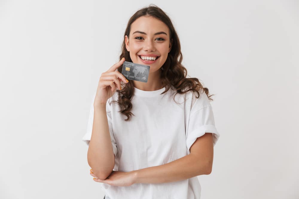 Portrait,Of,A,Smiling,Young,Casual,Brunette,Woman,Holding,Credit