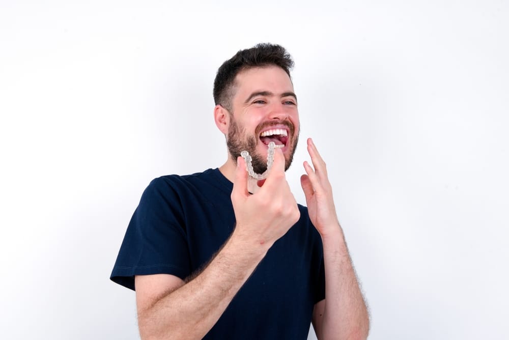 Happy,Young,Caucasian,Man,Wearing,Black,T-shirt,Over,White,Background