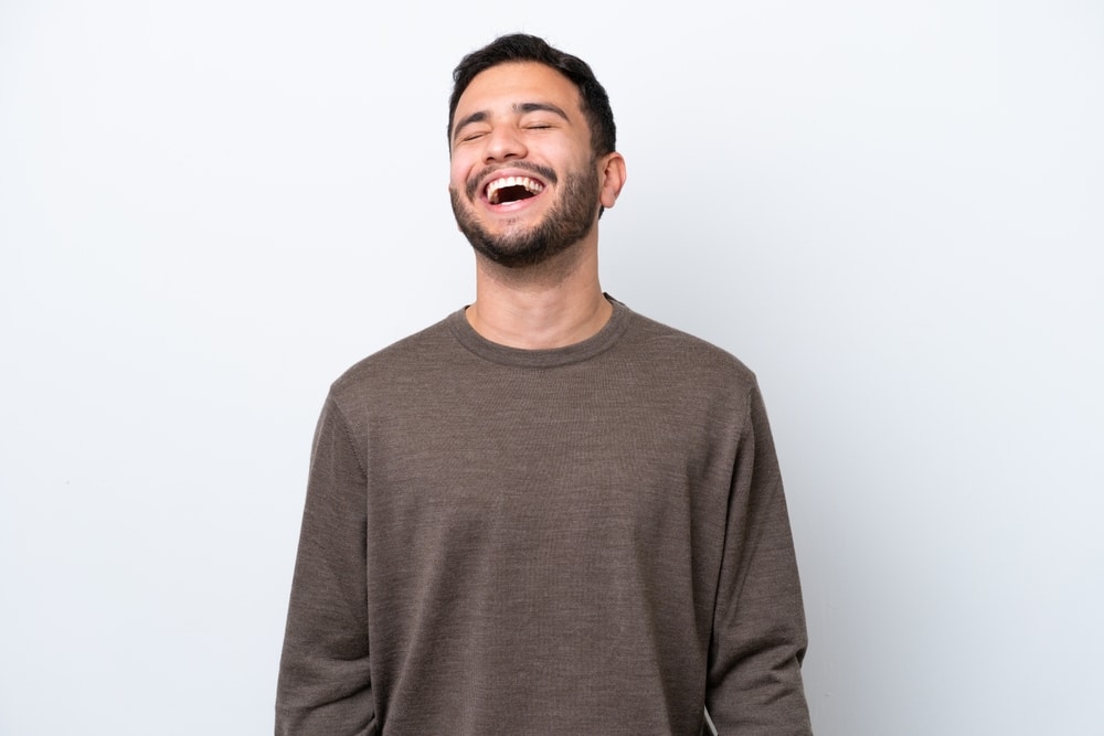 Young,Brazilian,Man,Isolated,On,White,Background,Laughing